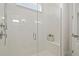Modern bathroom features a glass enclosed shower with white tile surround and built in bench at 15567 Gentle Rain Dr # 194, Winter Garden, FL 34787