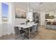 Elegant dining room with modern lighting, stylish decor, and ample natural light at 15567 Gentle Rain Dr # 194, Winter Garden, FL 34787