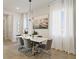 Bright dining room featuring a modern light fixture and coastal artwork at 15567 Gentle Rain Dr # 194, Winter Garden, FL 34787