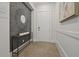Elegant foyer with decorative mirror, console table, and stylish wall paneling at 15567 Gentle Rain Dr # 194, Winter Garden, FL 34787