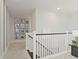 Hallway with picture frame collage and white railings at 15567 Gentle Rain Dr # 194, Winter Garden, FL 34787