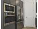 Sleek stainless steel refrigerator, microwave, and oven combination in a modern kitchen at 15567 Gentle Rain Dr # 194, Winter Garden, FL 34787