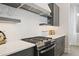 Modern kitchen with stainless steel gas range, white countertops, and contemporary backsplash at 15567 Gentle Rain Dr # 194, Winter Garden, FL 34787