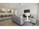 Open-concept living room with modern kitchen island and casual seating area at 15567 Gentle Rain Dr # 194, Winter Garden, FL 34787