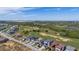 An aerial view of a neighborhood shows modern homes next to a golf course in a planned community at 15847 Vetta Dr, Bella Collina, FL 34756