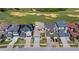 An aerial view shows modern homes next to a well-manicured golf course with sand traps at 15847 Vetta Dr, Bella Collina, FL 34756