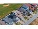 An aerial view shows modern homes adjacent to a golf course with mature landscaping at 15847 Vetta Dr, Bella Collina, FL 34756