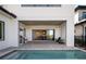 Lovely outdoor space with pool and summer kitchen and sliding doors to the indoor living space at 15847 Vetta Dr, Bella Collina, FL 34756