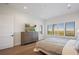 Comfortable bedroom with plantation shutters, wood floors, and dresser featuring a scenic view at 15847 Vetta Dr, Bella Collina, FL 34756