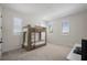 Bright bedroom with neutral carpet, shutters, and a wood bunk bed at 15847 Vetta Dr, Bella Collina, FL 34756