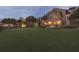Elegant stone building with a sprawling lawn, creating a luxurious estate feel at twilight at 15847 Vetta Dr, Bella Collina, FL 34756