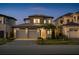 Beautiful two-story home featuring a well-manicured lawn, stone accents, and a spacious two-car garage at 15847 Vetta Dr, Bella Collina, FL 34756