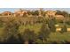An exterior view of a Tuscan-style neighborhood with a large expanse of green space and landscaping at 15847 Vetta Dr, Bella Collina, FL 34756