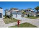 Landscaped yard and two-car garage are featured in the exterior of this modern two-story home at 15847 Vetta Dr, Bella Collina, FL 34756