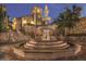 Beautiful water fountain with a stately building in the background with stone facade and stairs at 15847 Vetta Dr, Bella Collina, FL 34756