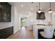 Bright, modern kitchen featuring a waterfall island, white cabinets, and stainless steel appliances at 15847 Vetta Dr, Bella Collina, FL 34756