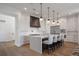 Modern kitchen with a waterfall island, stainless steel appliances, and ample cabinet space at 15847 Vetta Dr, Bella Collina, FL 34756