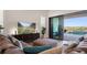 Modern living room featuring a plush sofa, stylish decor, and sliding glass doors leading to the pool at 15847 Vetta Dr, Bella Collina, FL 34756