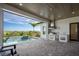 Inviting outdoor area with a pool, waterfall feature, and a well-equipped summer kitchen under a covered patio at 15847 Vetta Dr, Bella Collina, FL 34756