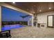 Inviting outdoor area with a pool, waterfall feature, and a well-equipped summer kitchen under a covered patio at 15847 Vetta Dr, Bella Collina, FL 34756