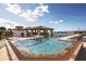 Relaxing pool area features a hot tub, sun loungers, and covered seating, perfect for outdoor enjoyment at 15847 Vetta Dr, Bella Collina, FL 34756