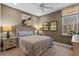 Cozy bedroom with neutral walls, a window, and lamps on either side of the comfortably decorated bed at 16144 Parkwyn St, Winter Garden, FL 34787