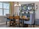 Dining room featuring modern chandelier, furniture, and decorative wall mirror at 16144 Parkwyn St, Winter Garden, FL 34787