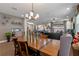 Open concept dining area with wood look tile, neutral paint, and modern decor at 16144 Parkwyn St, Winter Garden, FL 34787