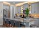 Updated kitchen boasts gray cabinets, stainless steel appliances, and a large granite island at 16144 Parkwyn St, Winter Garden, FL 34787