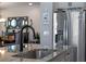 Close up of the granite island with a stainless steel refrigerator in the background at 16144 Parkwyn St, Winter Garden, FL 34787