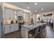 Modern kitchen featuring gray cabinets, stainless steel appliances, and a granite island with seating at 16144 Parkwyn St, Winter Garden, FL 34787