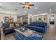 Open-concept living room and kitchen with modern furnishings and hardwood floors at 16144 Parkwyn St, Winter Garden, FL 34787