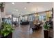 Open concept living room with wood look tile, neutral paint, and modern decor at 16144 Parkwyn St, Winter Garden, FL 34787