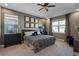 Main bedroom with tray ceiling, two windows and ensuite bathroom at 16144 Parkwyn St, Winter Garden, FL 34787