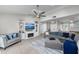 Well-lit living room featuring tile floors, modern furniture, and a ceiling fan at 1685 Colleen Dr, Belle Isle, FL 32809