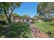 A beautiful backyard featuring a brick pathway leading up to the home at 215 Forrest Dr, Sanford, FL 32773