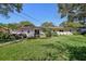 Well-manicured lawn and landscaping enhance the backyard of this property at 215 Forrest Dr, Sanford, FL 32773