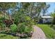 Beautiful backyard featuring a brick pathway and a charming garden shed at 215 Forrest Dr, Sanford, FL 32773