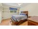 Bedroom with wood floors, ceiling fan, and sunny view from the large window at 215 Forrest Dr, Sanford, FL 32773