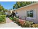 Close up of the home's colorful flower beds, greenery and windows with white shutters at 215 Forrest Dr, Sanford, FL 32773
