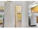 Hallway view into the powder room, and laundry room at 215 Forrest Dr, Sanford, FL 32773