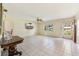 Spacious living room with tile flooring, ceiling fan, and a large window for natural light at 215 Forrest Dr, Sanford, FL 32773