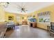 Large, sunny room features ceiling fan, neutral carpet, and many windows at 215 Forrest Dr, Sanford, FL 32773