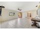 Bright living room with tile floors, a ceiling fan, and a view of the front yard at 215 Forrest Dr, Sanford, FL 32773