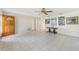 Open living room featuring tile flooring, a ceiling fan, and a view of the front door at 215 Forrest Dr, Sanford, FL 32773