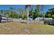 View of backyard with a well maintained wooden fence and mature trees at 2156 Fish Eagle St, Clermont, FL 34714
