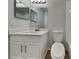 Updated bathroom featuring white vanity, modern lighting, and a standard toilet at 2156 Fish Eagle St, Clermont, FL 34714