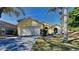 Charming yellow home with a well-maintained lawn and a two-car garage at 2156 Fish Eagle St, Clermont, FL 34714