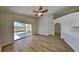 Bright living room with wood floors and sliding glass doors to a screened patio at 2156 Fish Eagle St, Clermont, FL 34714
