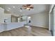 Open-concept kitchen and living room with modern white cabinets and wood-look floors at 2156 Fish Eagle St, Clermont, FL 34714